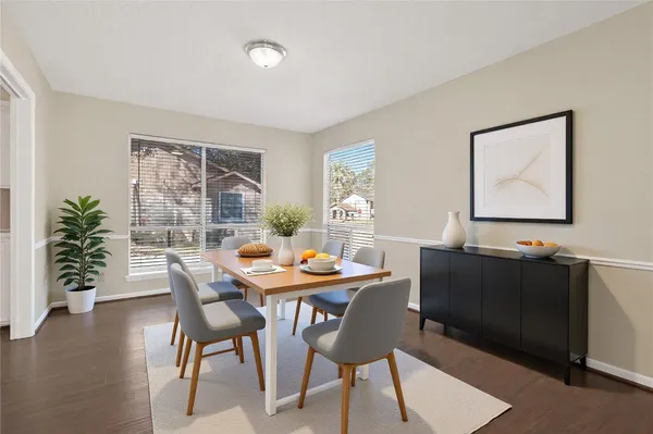 a dining room with furniture and wooden floor