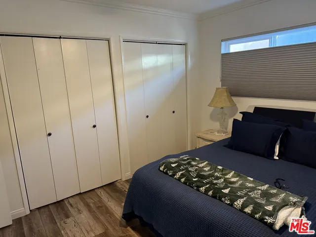 a bedroom with a bed and a mirror