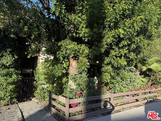 a wooden bench sitting in the middle of a forest