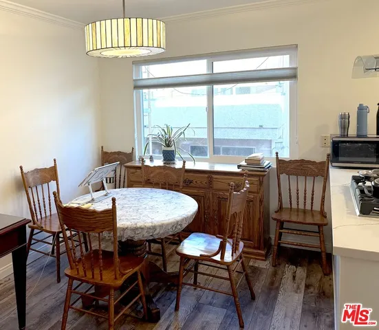 a view of a dining room with furniture wooden floor and chandelier