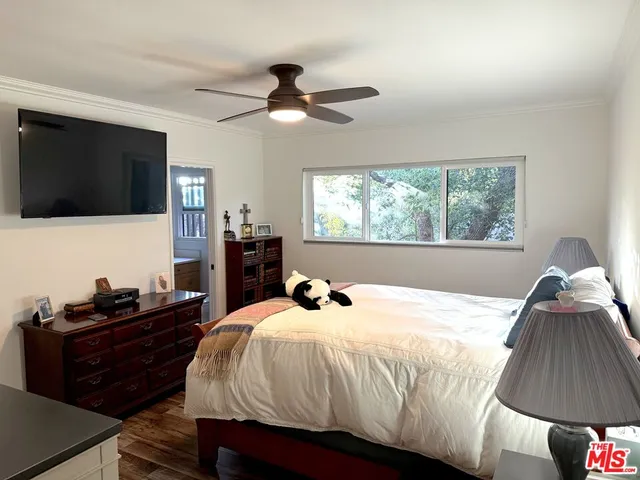 a bedroom with a bed and a flat tv screen