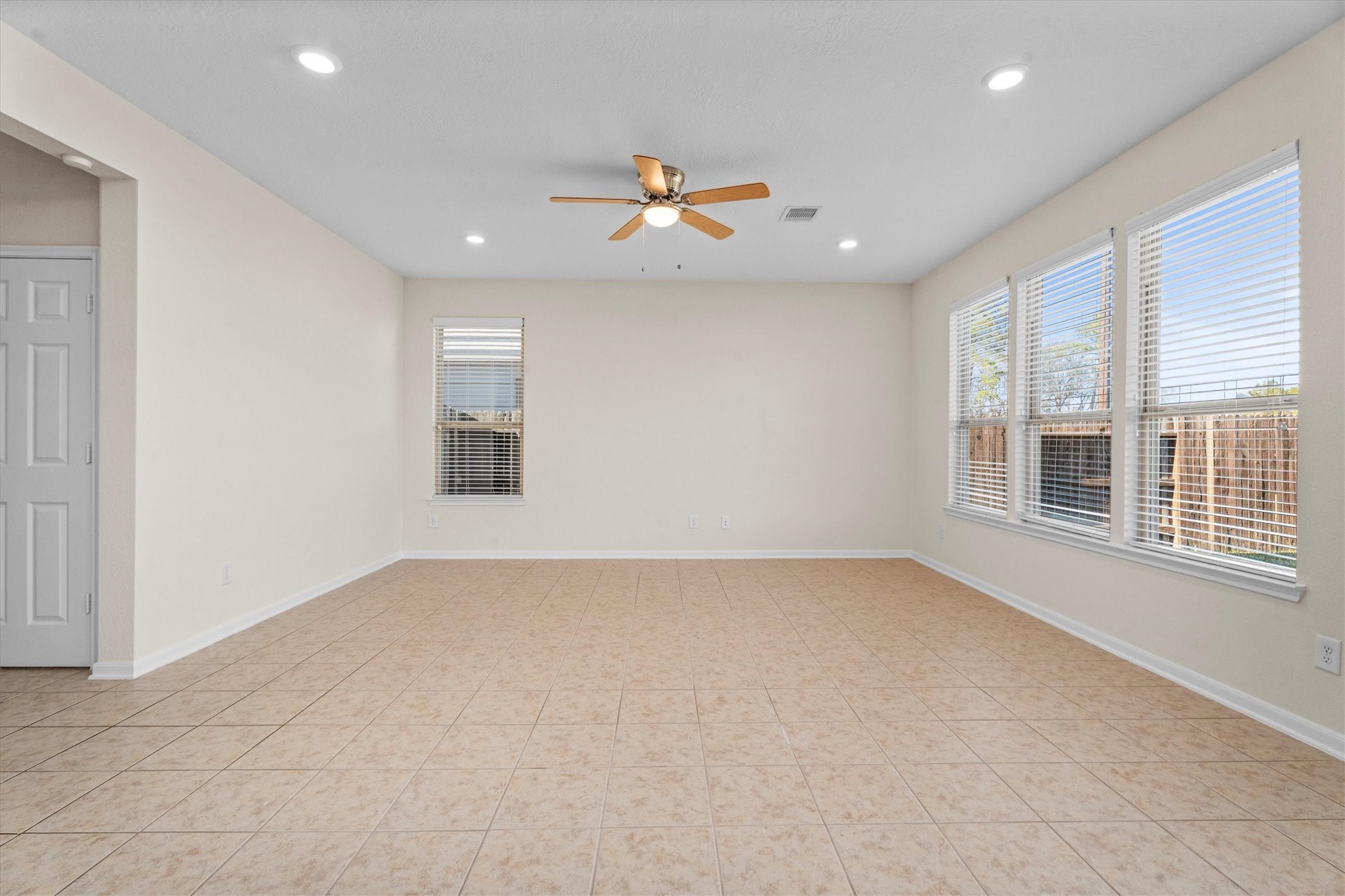 4022 Streambed Trail Houston, TX 77068 - Photo 13 of 32 an empty room with chandelier fan and windows