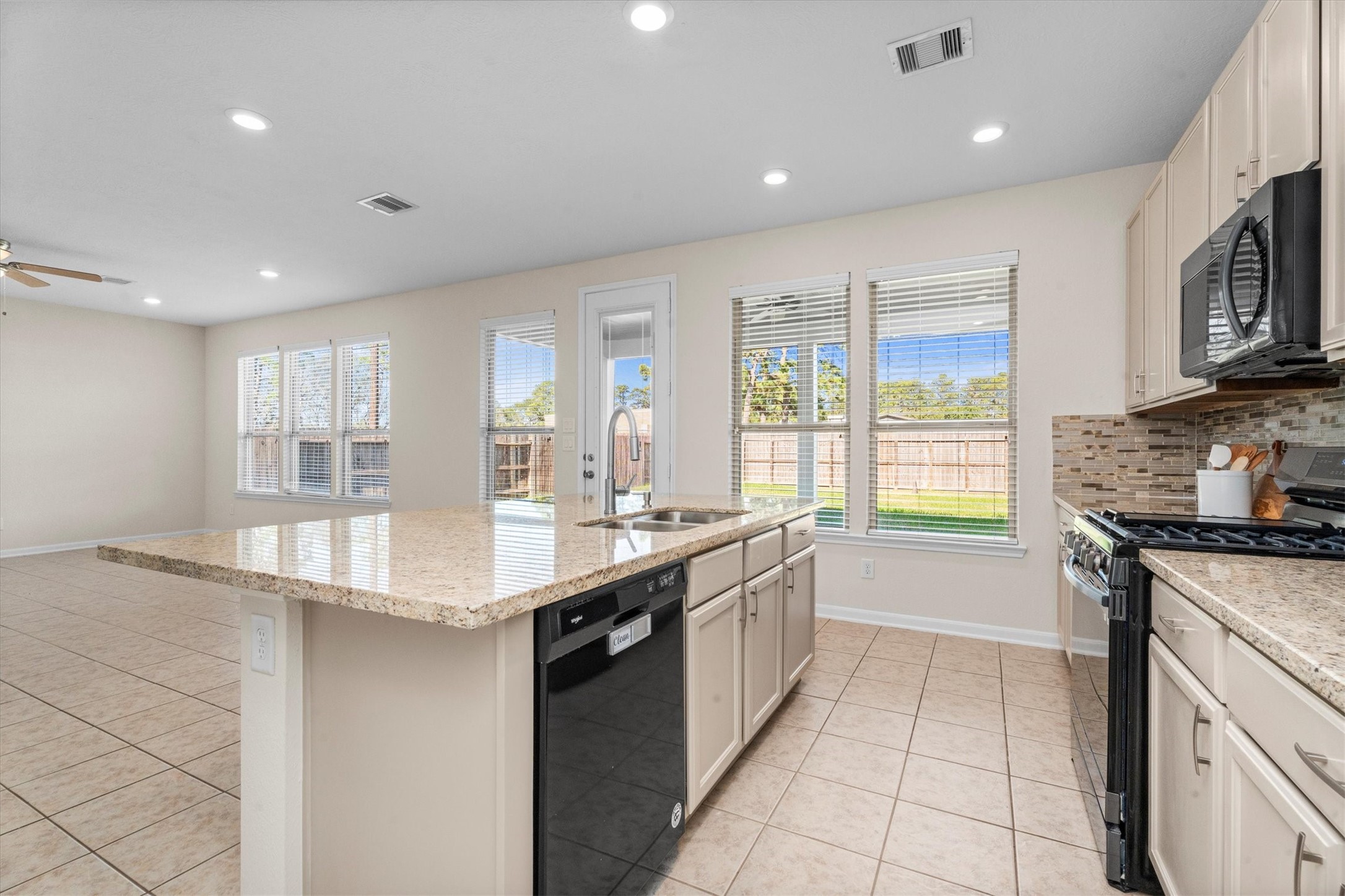 4022 Streambed Trail Houston, TX 77068 - Photo 14 of 32 a large kitchen with stainless steel appliances granite countertop a sink and cabinets