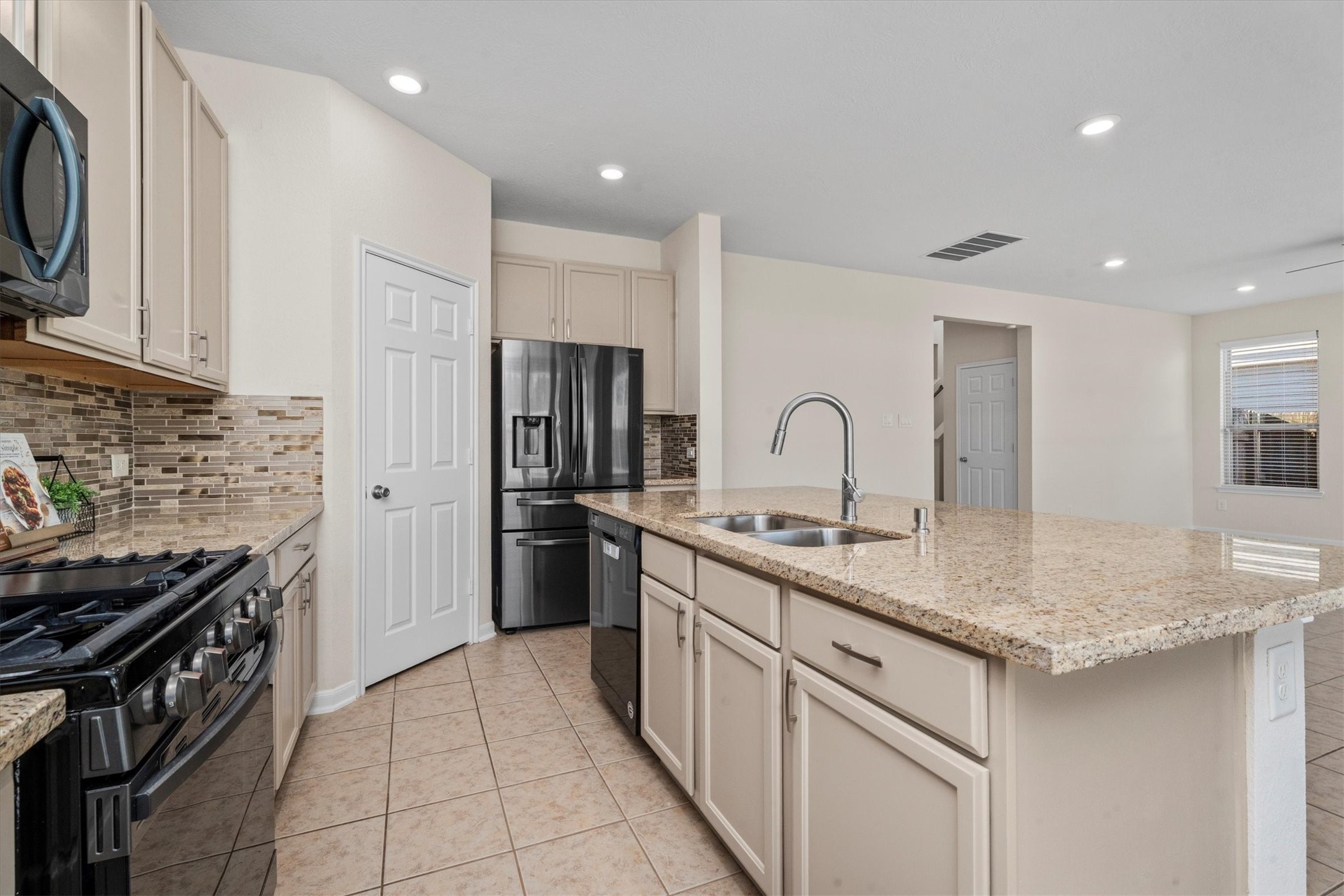 4022 Streambed Trail Houston, TX 77068 - Photo 16 of 32 a kitchen with stainless steel appliances granite countertop a sink stove and refrigerator