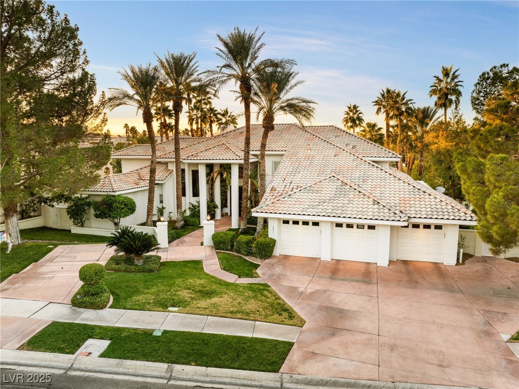 2057 Troon Drive Henderson, NV 89074 - Photo 14 of 41 Mediterranean / spanish-style house featuring a tile roof, a garage, concrete driveway, and stucco siding