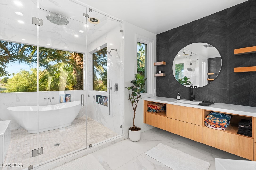 2057 Troon Drive Henderson, NV 89074 - Photo 17 of 41 Bathroom with light marble finish flooring, vanity, a freestanding bath, and a marble finish shower