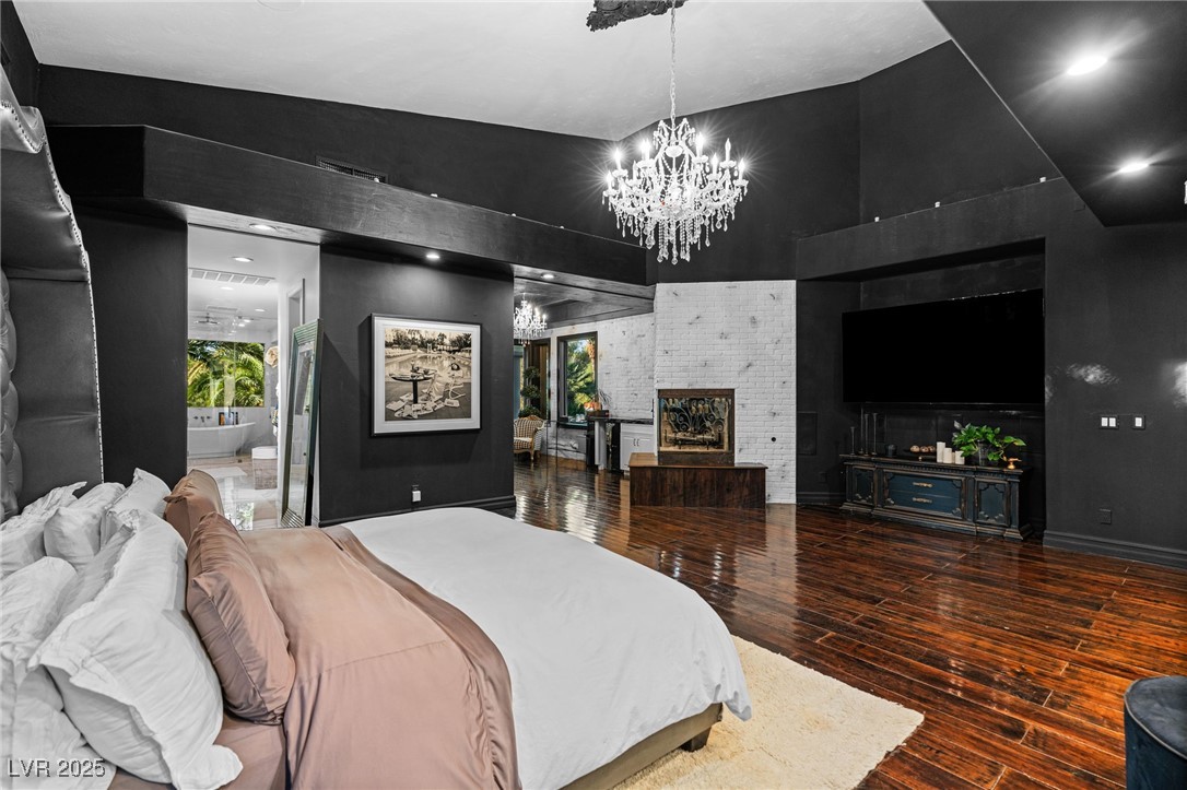 2057 Troon Drive Henderson, NV 89074 - Photo 19 of 41 Bedroom with dark wood-type flooring, recessed lighting, and a chandelier