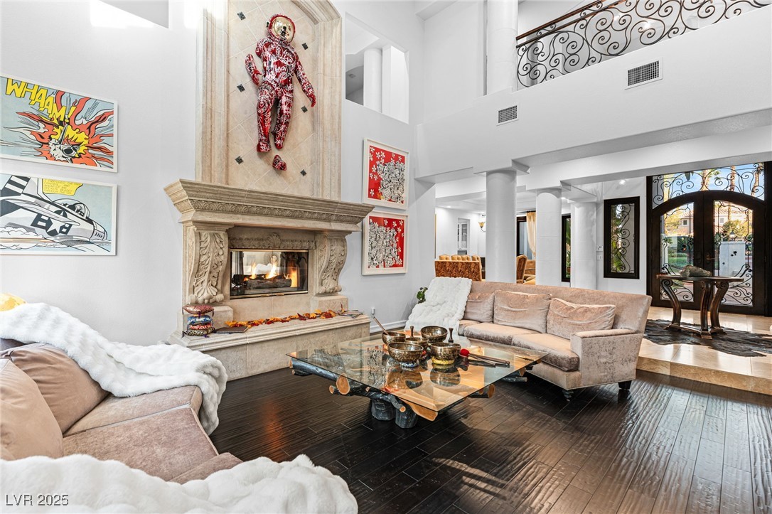 2057 Troon Drive Henderson, NV 89074 - Photo 4 of 41 Living room with wood-type flooring, french doors, a high ceiling, and a high end fireplace