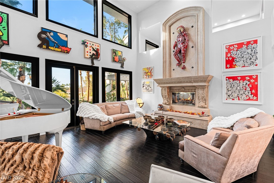 2057 Troon Drive Henderson, NV 89074 - Photo 8 of 41 Living room featuring dark wood-style floors, a towering ceiling, and a fireplace
