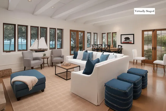 a living room with furniture and large windows