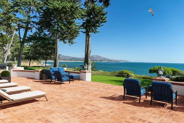 a view of a swimming pool and lounge chairs