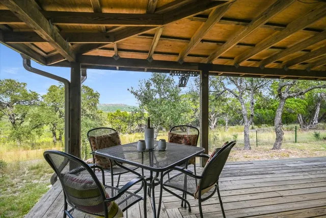 a view of a patio with table and chairs and wooden floor