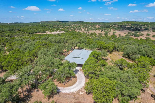 aerial view of a house with a yard