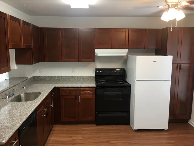 a kitchen with a refrigerator and a sink