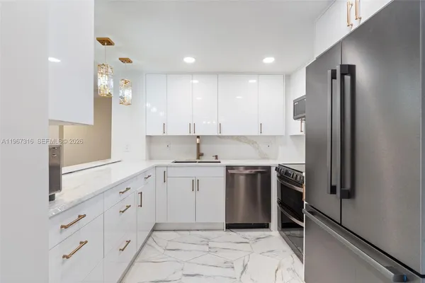 a kitchen with granite countertop a refrigerator stove and sink
