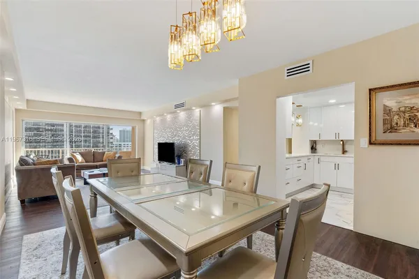 a view of a dining room with furniture and wooden floor