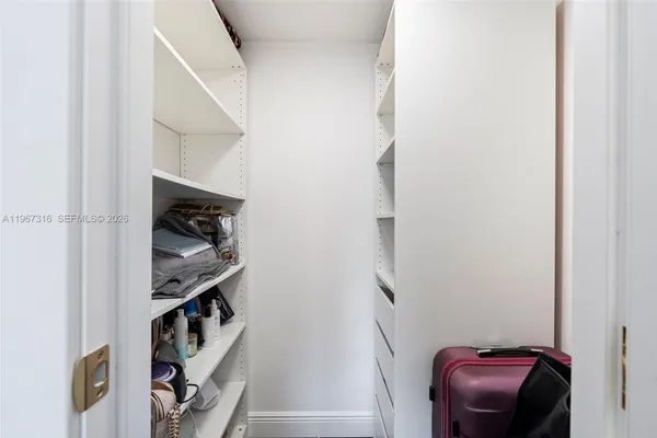 a view of hallway with stairs and a closet