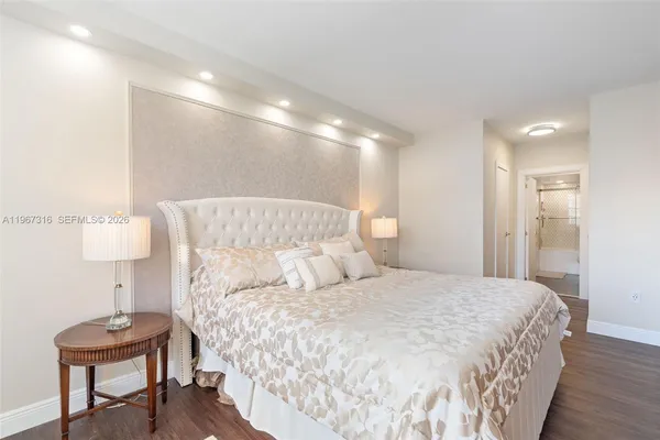 a large bed sitting in a bedroom and a table