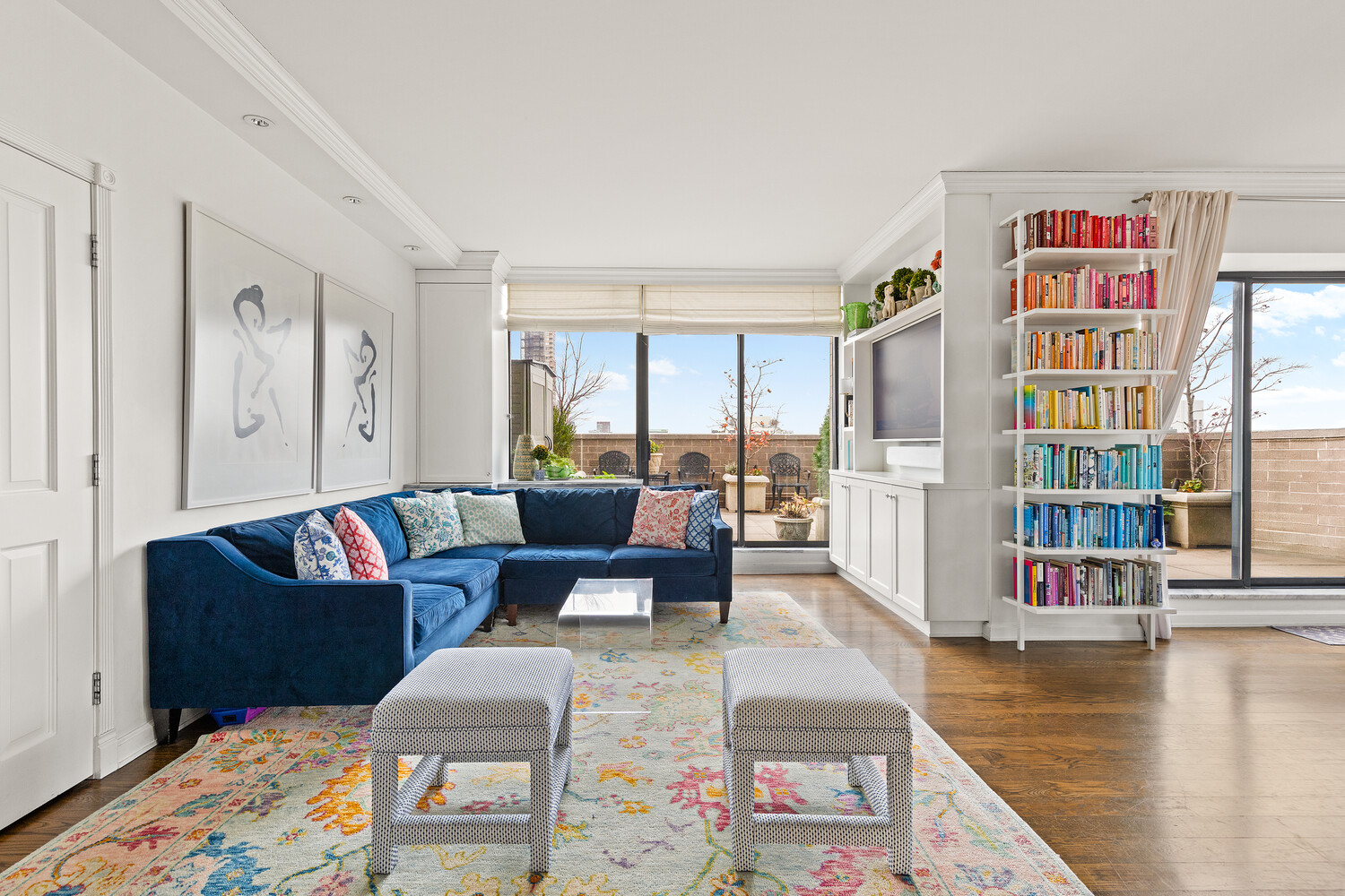 400 East 70th Street, Unit 3602 Manhattan, NY 10021 - Photo 14 of 20 a living room with fireplace furniture and a book shelf