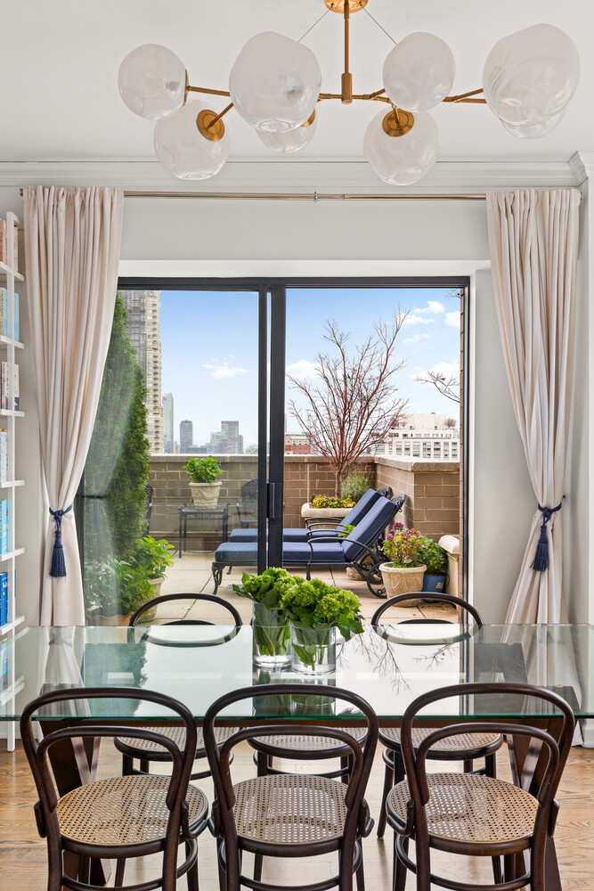 400 East 70th Street, Unit 3602 Manhattan, NY 10021 - Photo 16 of 20 a dining room with furniture and a floor to ceiling window