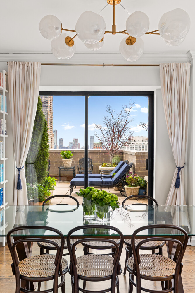 400 East 70th Street, Unit 3602 Manhattan, NY 10021 - Photo 17 of 20 a dining room with furniture a rug and a floor to ceiling window