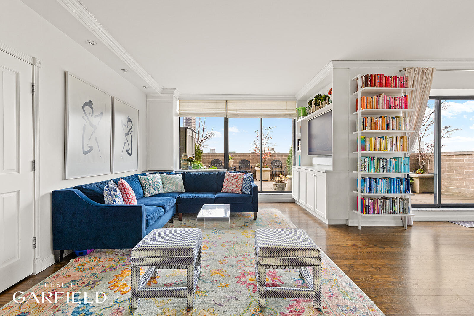 400 East 70th Street, Unit 3602 Manhattan, NY 10021 - Photo 3 of 21 a living room with fireplace furniture and a book shelf