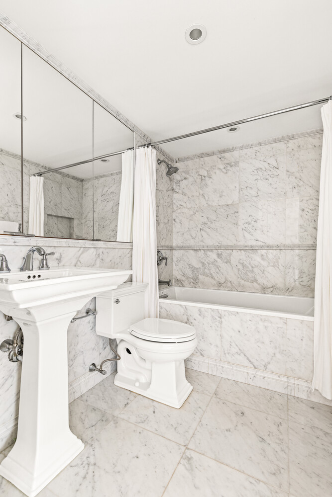 400 East 70th Street, Unit 3602 Manhattan, NY 10021 - Photo 4 of 20 a bathroom with a sink toilet and shower