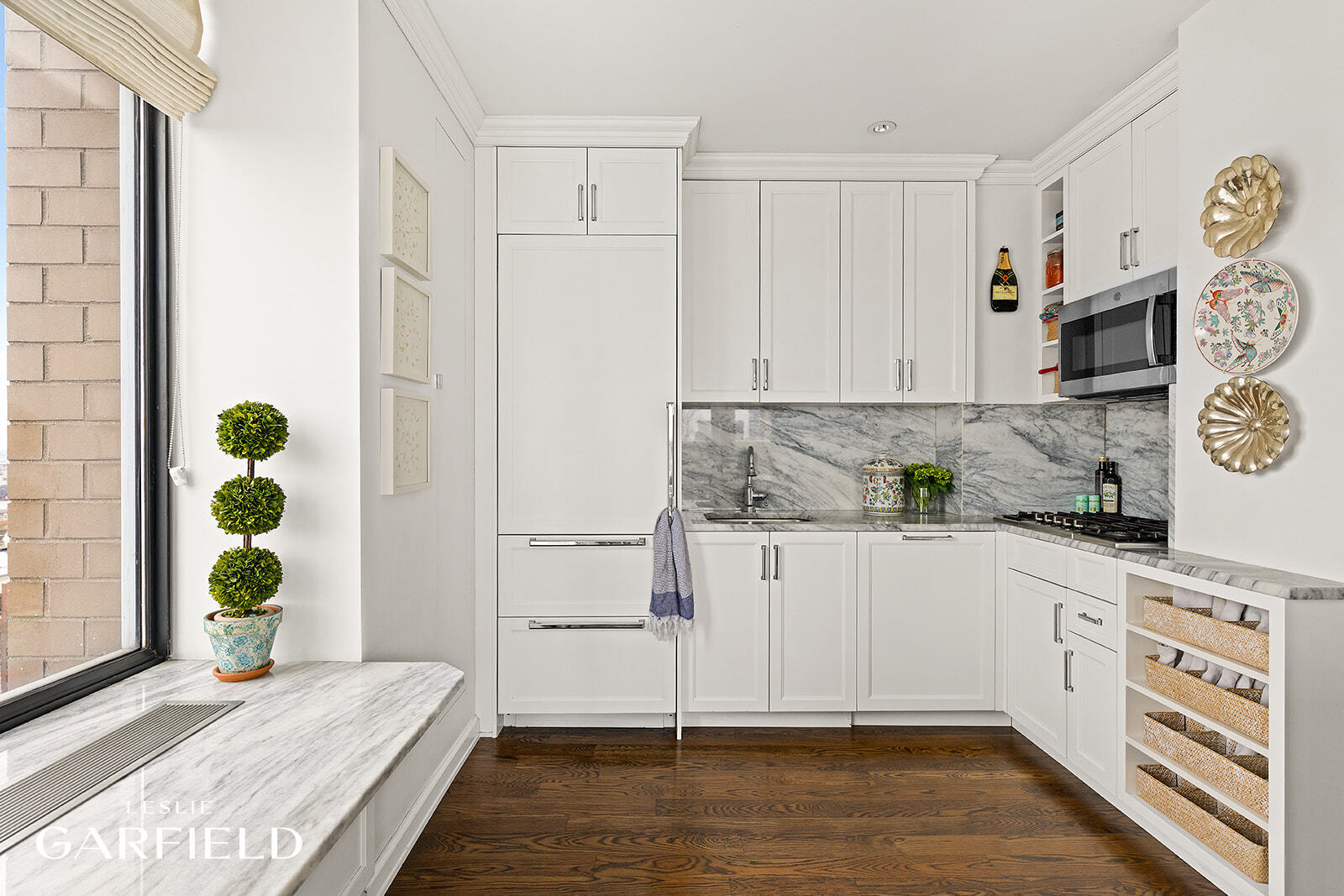 400 East 70th Street, Unit 3602 Manhattan, NY 10021 - Photo 6 of 21 a kitchen with stainless steel appliances white cabinets and a window
