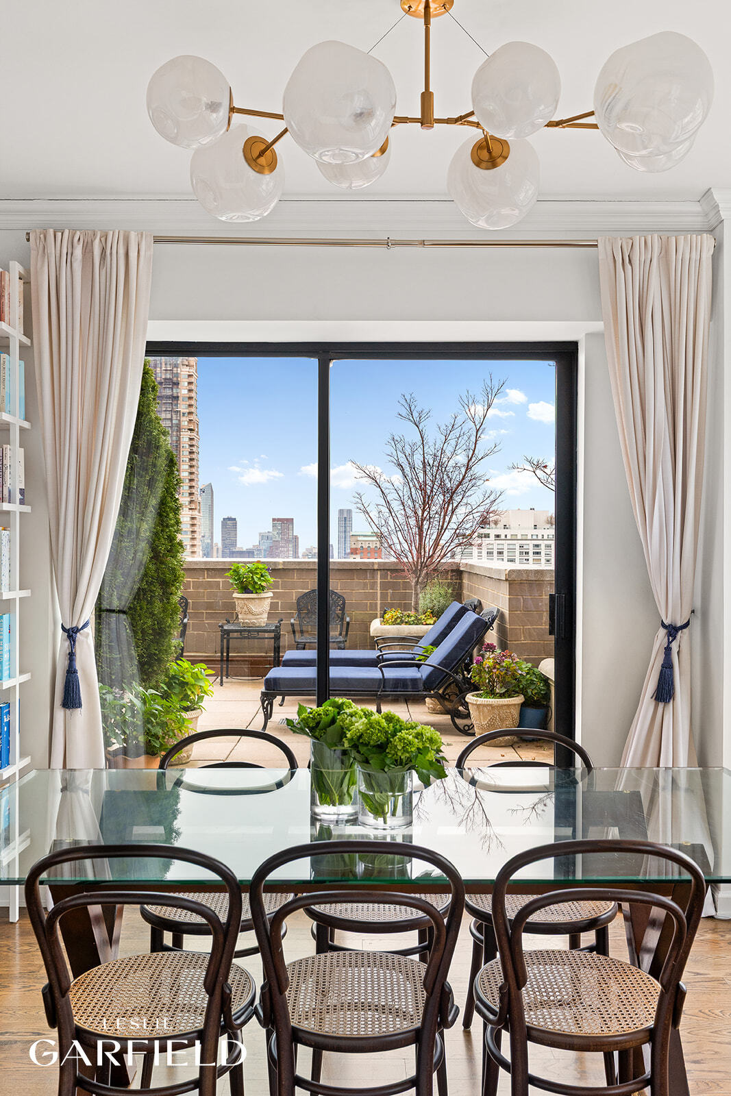 400 East 70th Street, Unit 3602 Manhattan, NY 10021 - Photo 7 of 21 a dining room with furniture a rug and a floor to ceiling window