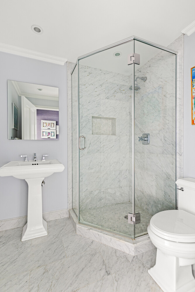400 East 70th Street, Unit 3602 Manhattan, NY 10021 - Photo 9 of 20 a bathroom with a shower a toilet and sink