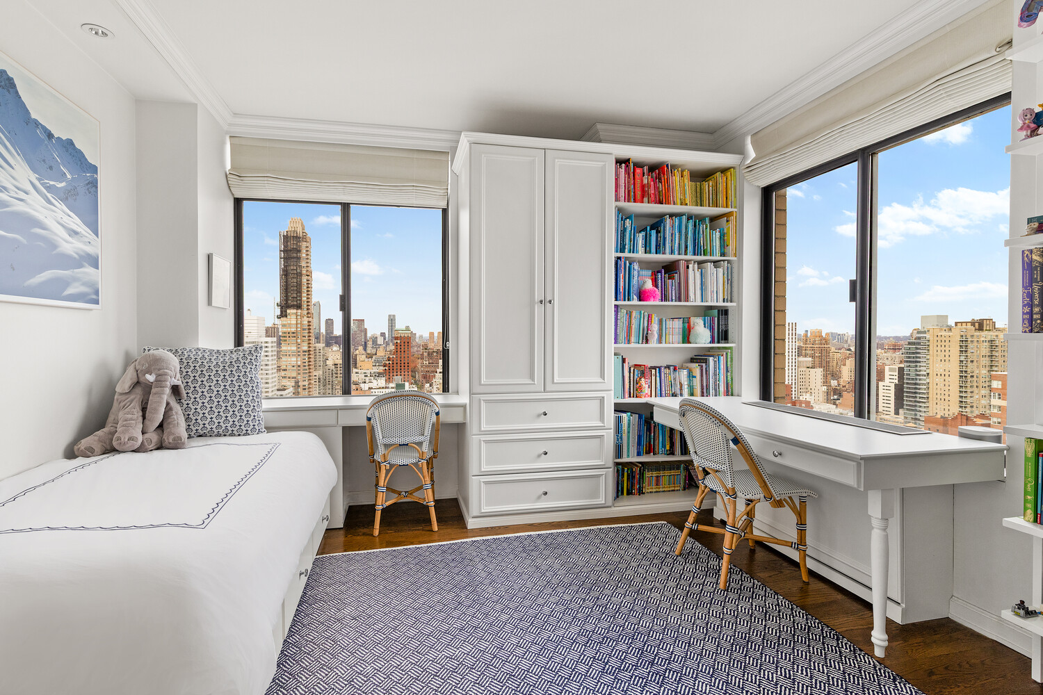 400 East 70th Street, Unit 3602 Manhattan, NY 10021 - Photo 10 of 20 a living room with furniture a bookshelf and a window