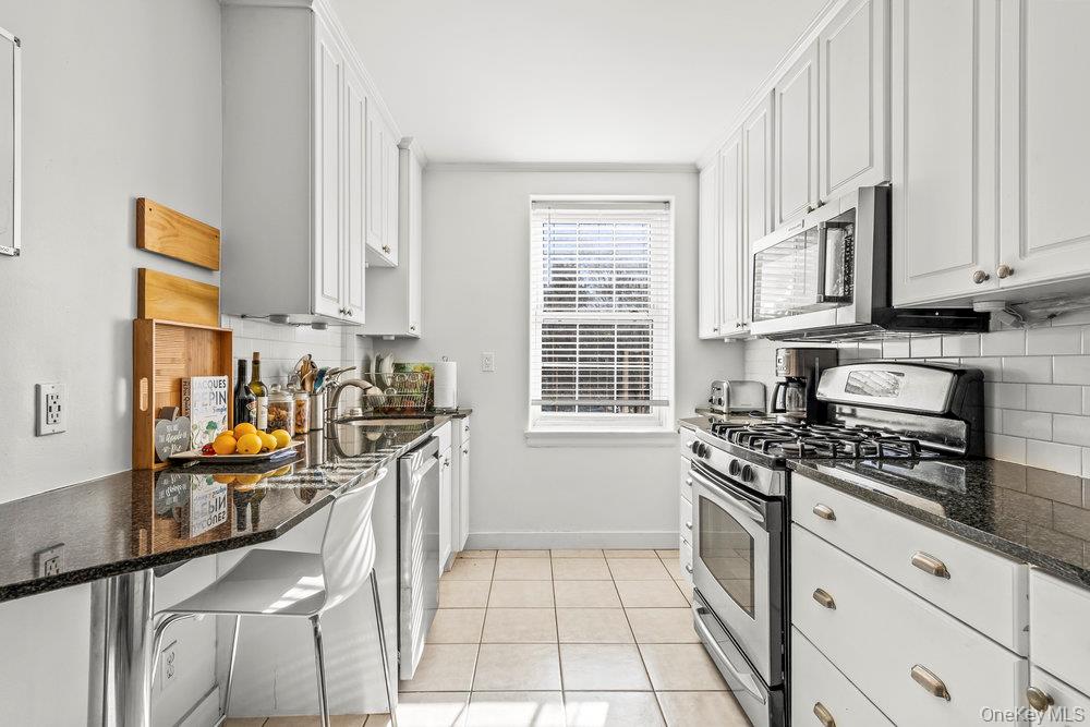 3 Alden Place, Unit 3A Bronxville, NY 10708 - Photo 5 of 22 a kitchen with stainless steel appliances granite countertop a stove a sink and a granite counter tops