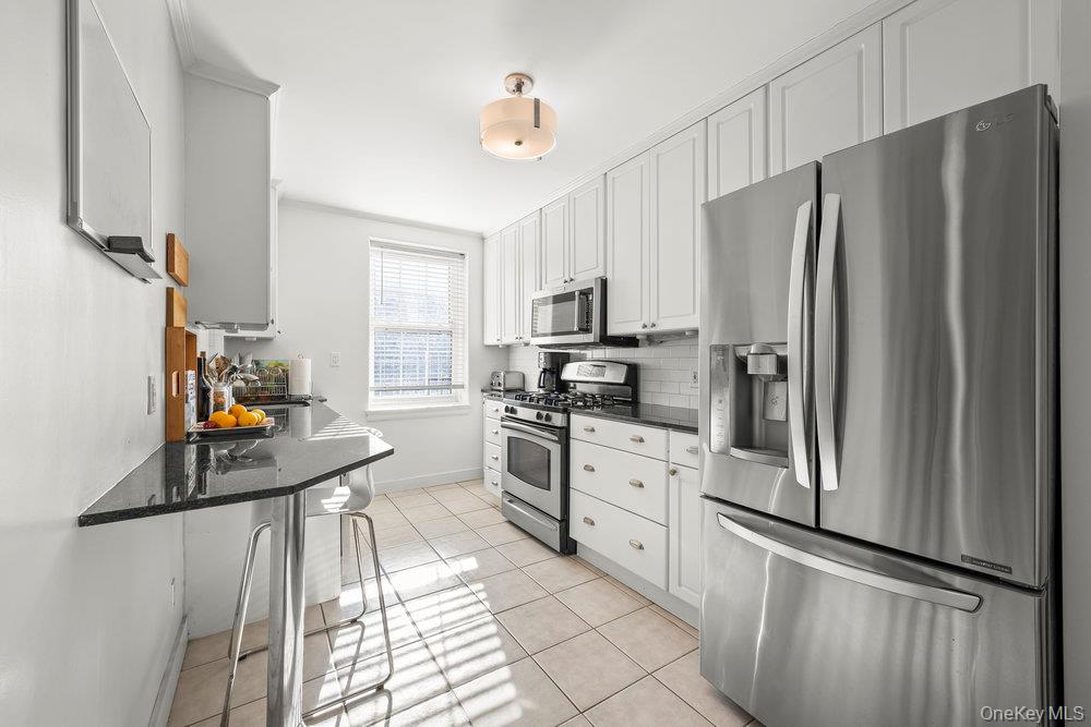 3 Alden Place, Unit 3A Bronxville, NY 10708 - Photo 6 of 22 a kitchen with stainless steel appliances a refrigerator sink and cabinets