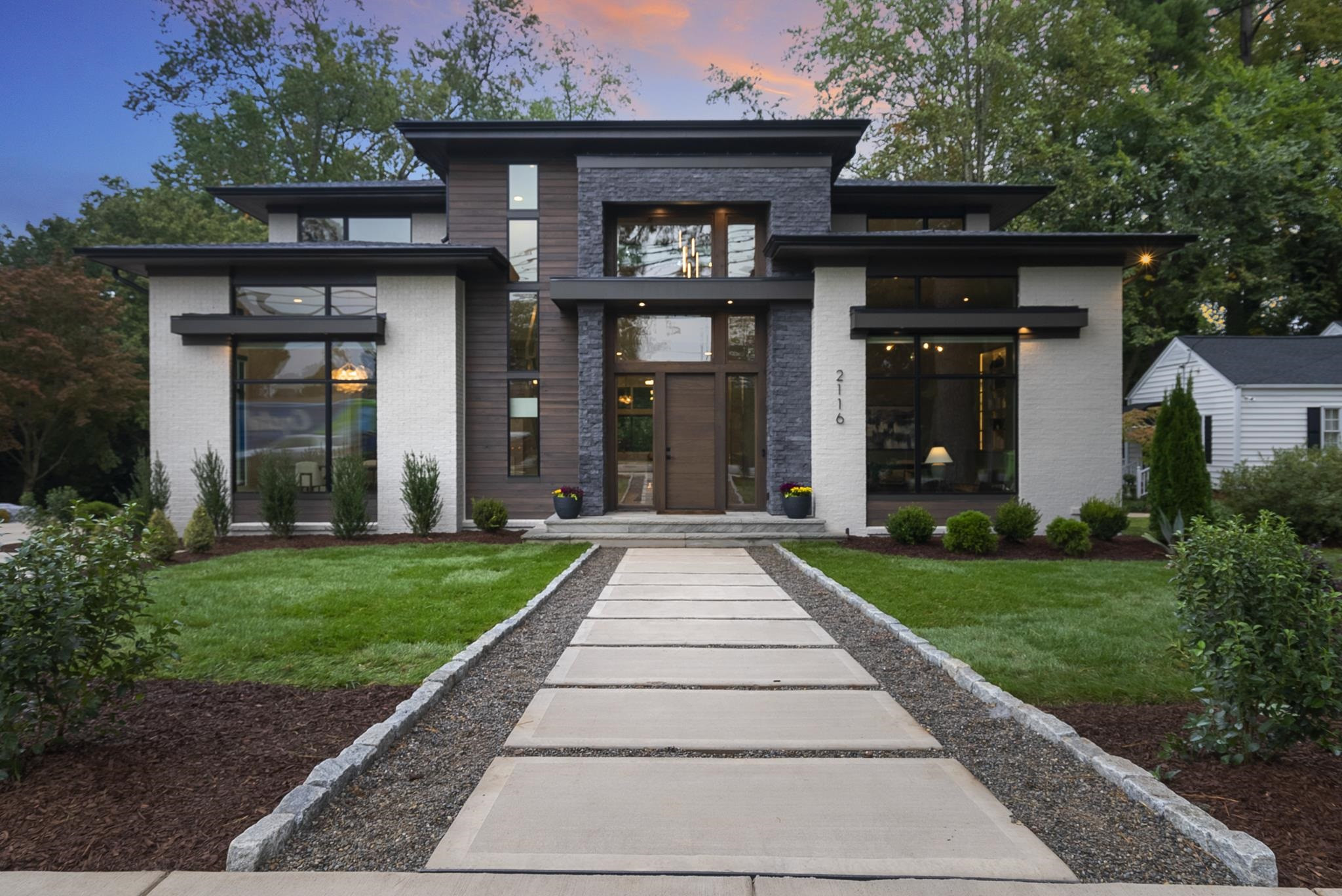 a front view of a house with a garden