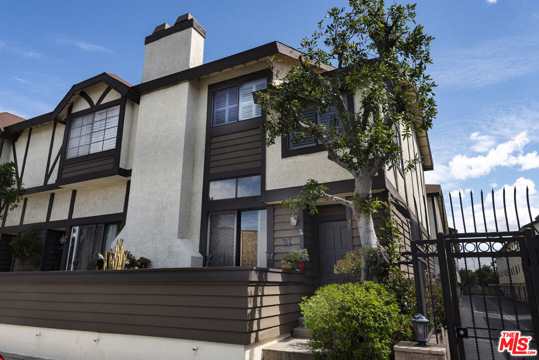 19355 Sherman Way, Unit 37 Reseda, CA 91335 - Photo 1 of 12 a front view of a house with a yard