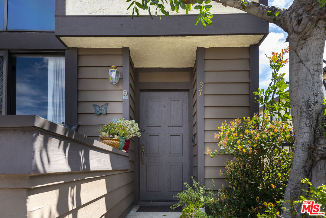 19355 Sherman Way, Unit 37 Reseda, CA 91335 - Photo 2 of 12 a house with a flower garden