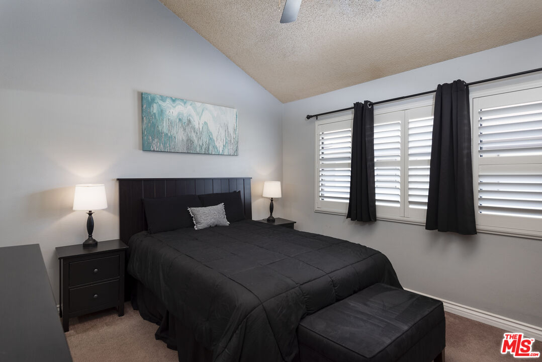 19355 Sherman Way, Unit 37 Reseda, CA 91335 - Photo 7 of 12 a bedroom with a bed and a couch next to a window