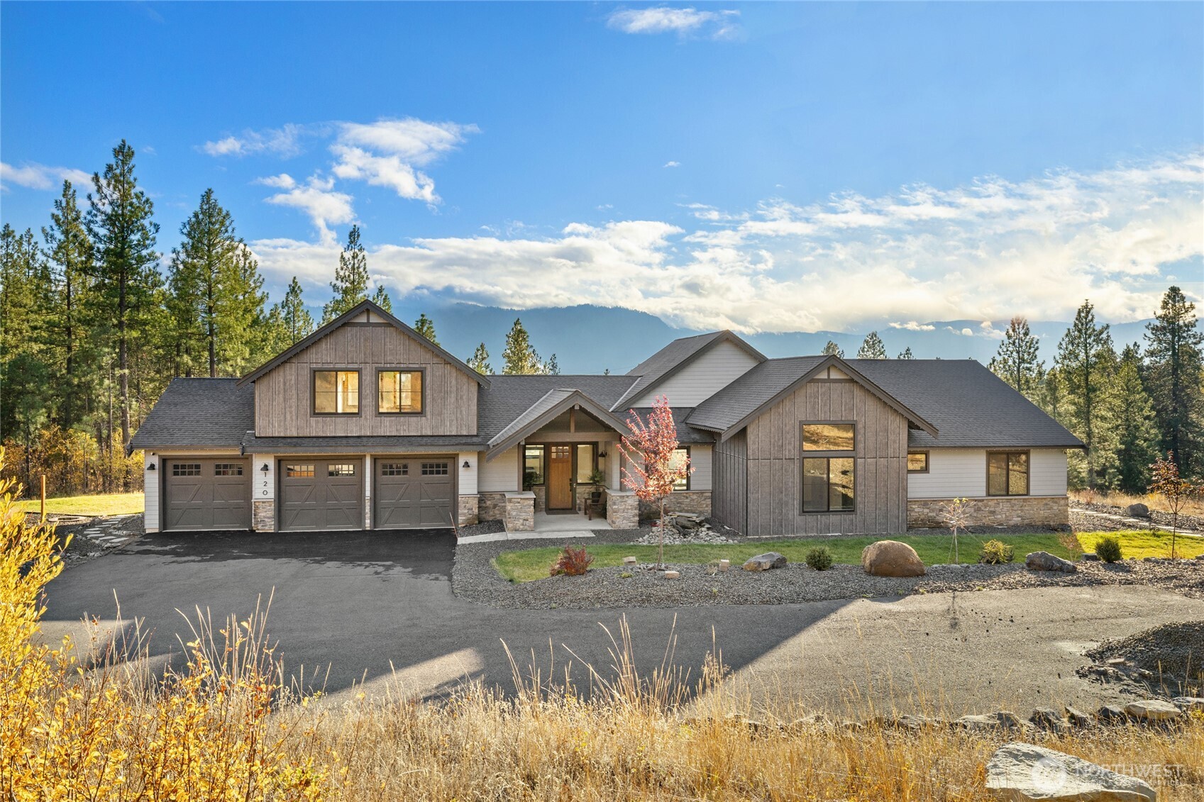 120 Owl Ridge Drive Cle Elum, WA 98922 - Photo 1 of 34 a front view of a house with a yard and garage