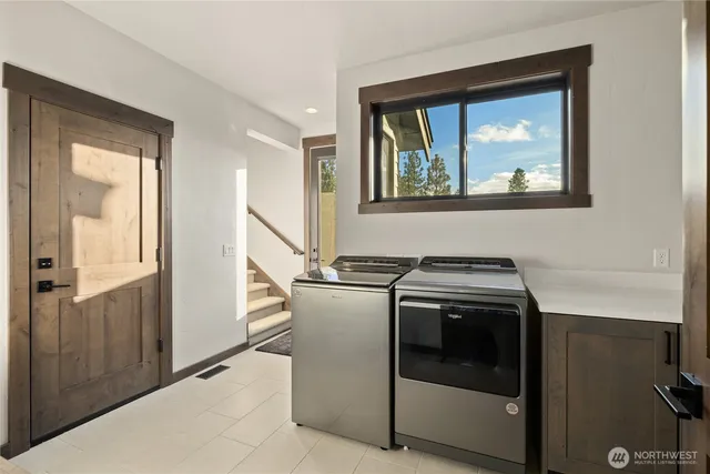 a spacious bedroom with a bed and two windows