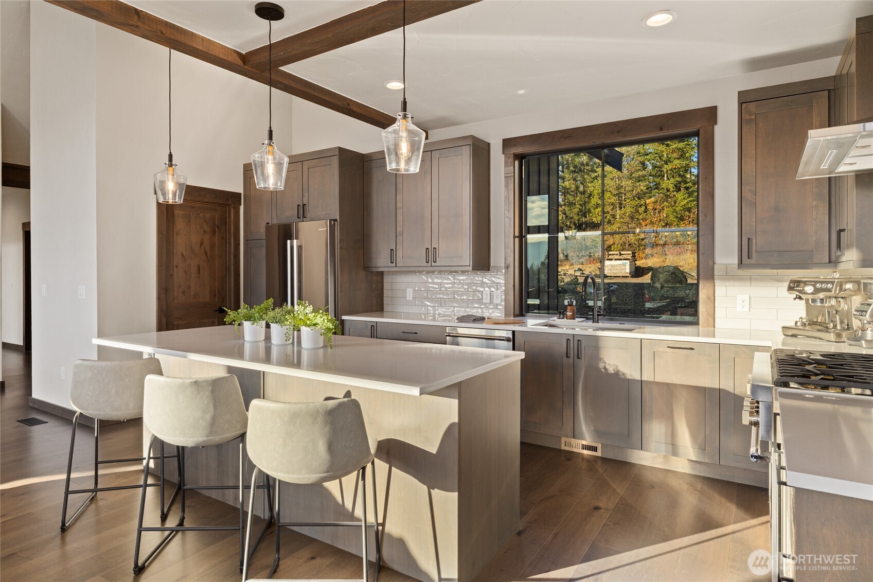 120 Owl Ridge Drive Cle Elum, WA 98922 - Photo 10 of 34 a kitchen with a table chairs refrigerator and cabinets