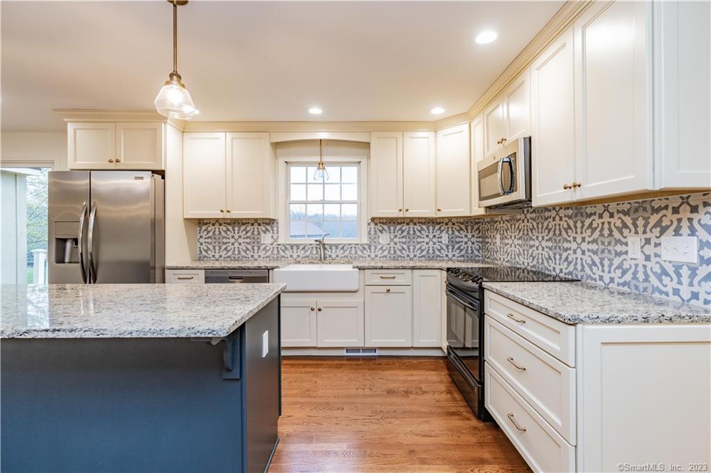 1241 Halladay Avenue West Suffield, CT 06078 - Photo 3 of 29 a kitchen with stainless steel appliances granite countertop a sink stove and refrigerator