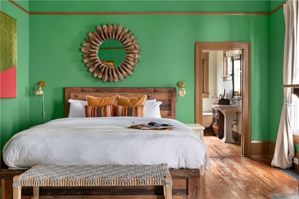 70 Kirkwood Road Northeast, Unit MH Atlanta, GA 30317 - Photo 18 of 36 a bedroom with a bed and a painting on the wall