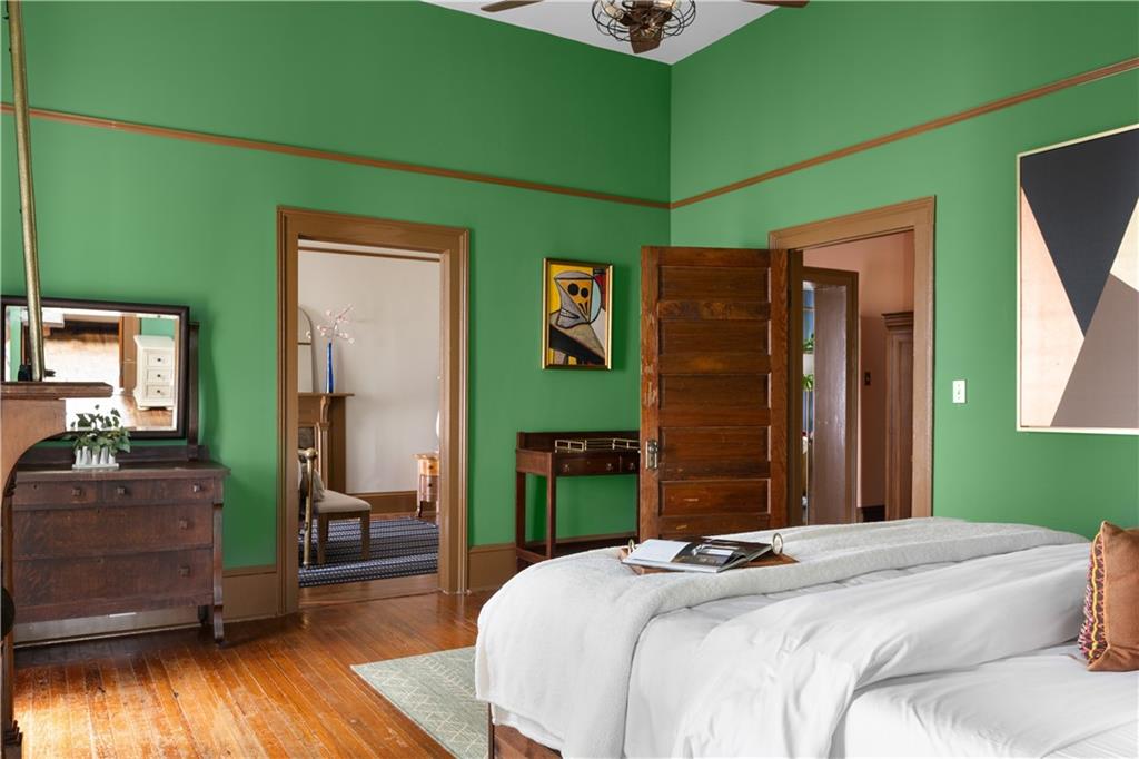 70 Kirkwood Road Northeast, Unit MH Atlanta, GA 30317 - Photo 22 of 36 a bedroom with a bed and a mirror