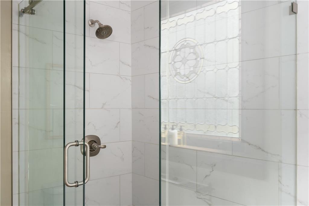 70 Kirkwood Road Northeast, Unit MH Atlanta, GA 30317 - Photo 31 of 36 a bathroom with a glass shower door