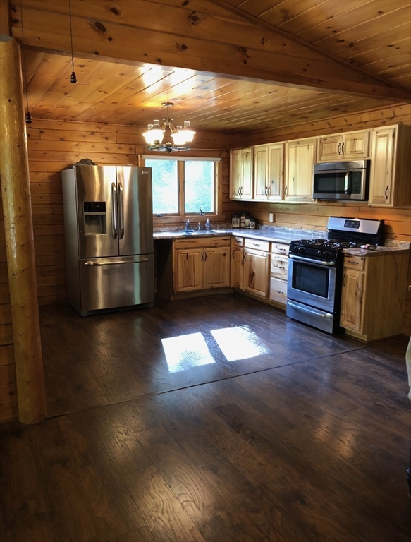 769 N Road Hardwick, MA 01037 - Photo 8 of 25 a kitchen with stainless steel appliances kitchen island granite countertop a large counter top couches and a fireplace