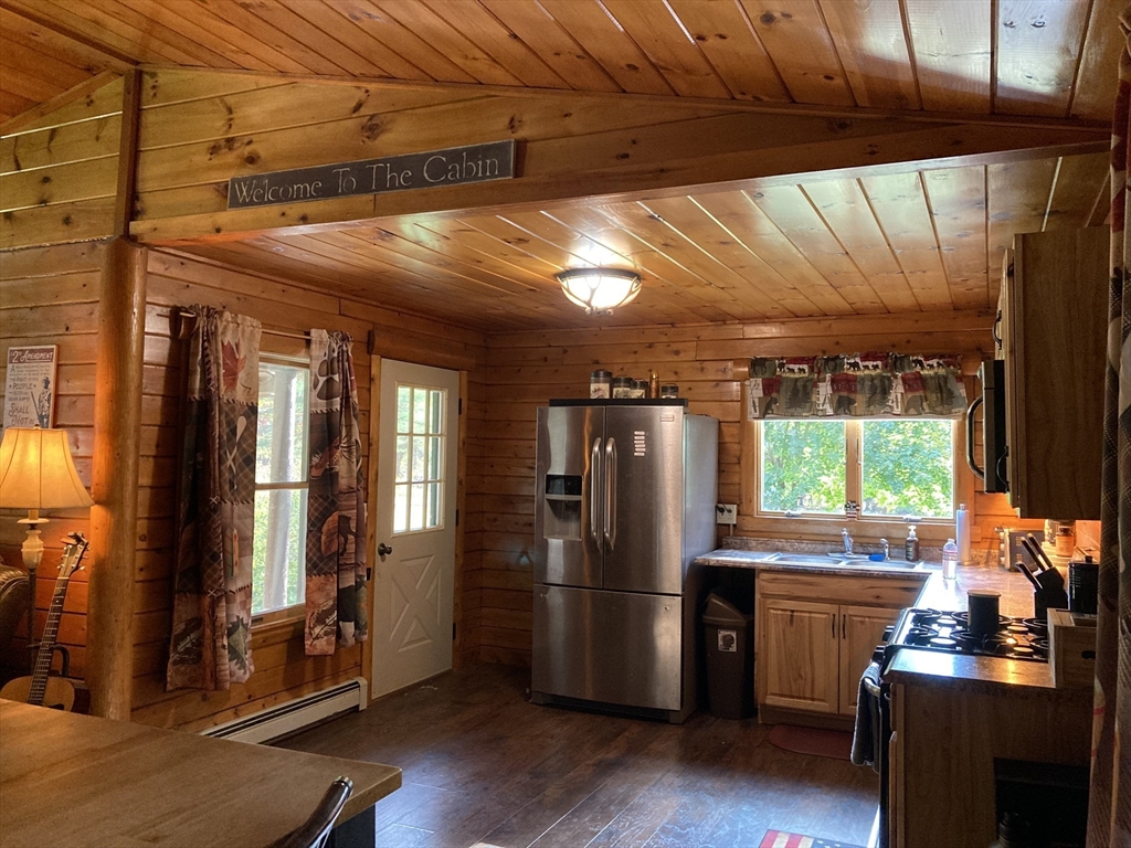 769 N Road Hardwick, MA 01037 - Photo 9 of 25 a kitchen with stainless steel appliances a refrigerator and wooden floor