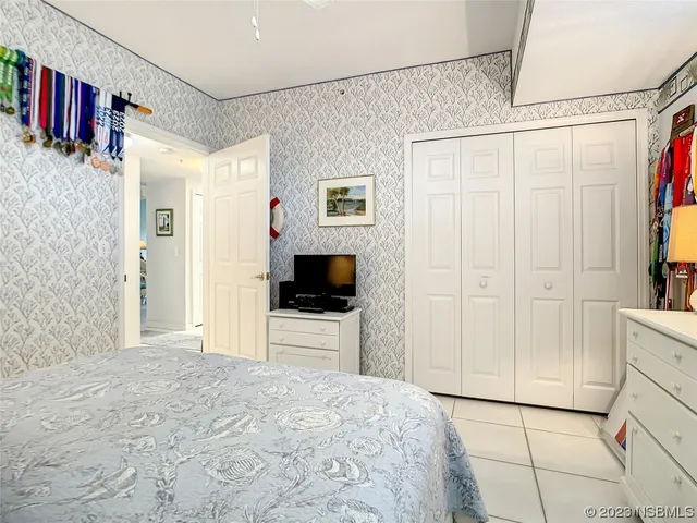 a bedroom with a bed and a flat tv screen in it