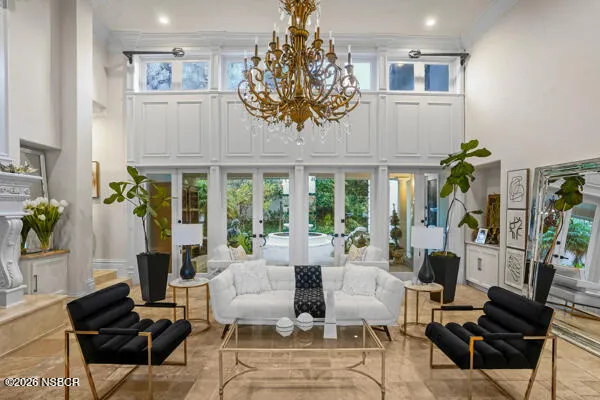 a bedroom with a large bed and a chandelier