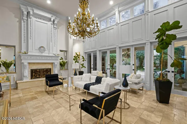 a living room with furniture fireplace and a large window