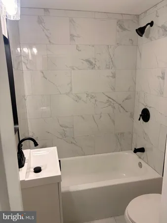 a bathroom with a sink a toilet and bathtub